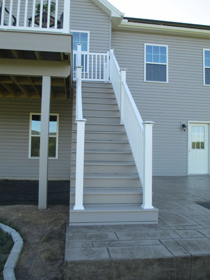 A white and light grey balcony with staircase